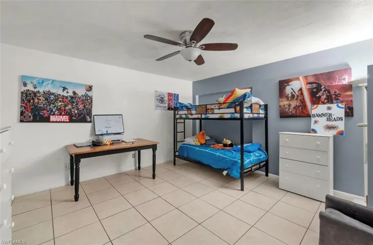 Tiled bedroom with ceiling fan