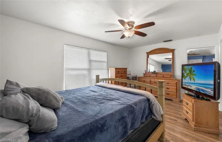 Bedroom featuring ceiling fan and light wood-type flooring