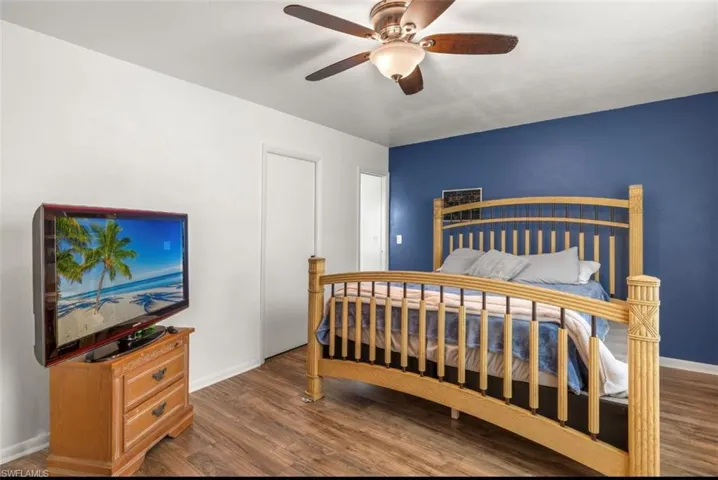 Bedroom with ceiling fan and dark hardwood / wood-style floors