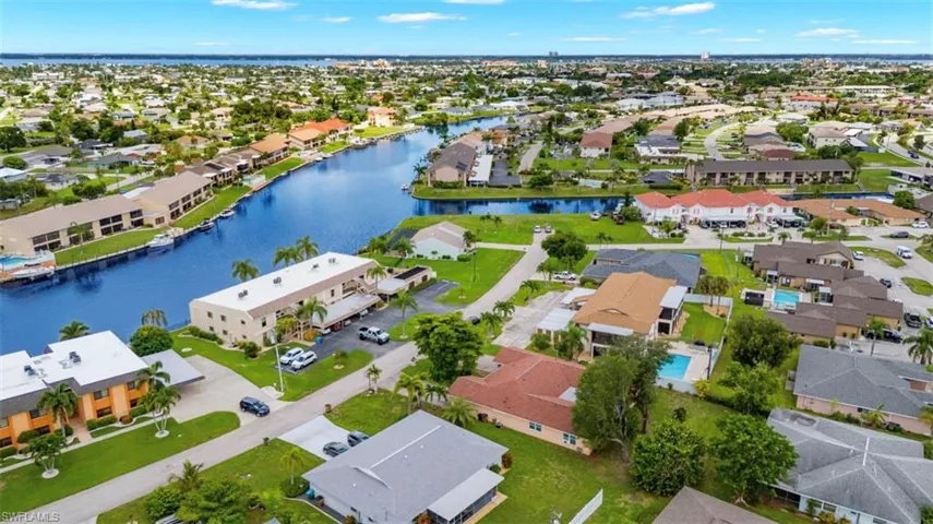 Birds eye view of property with a water view