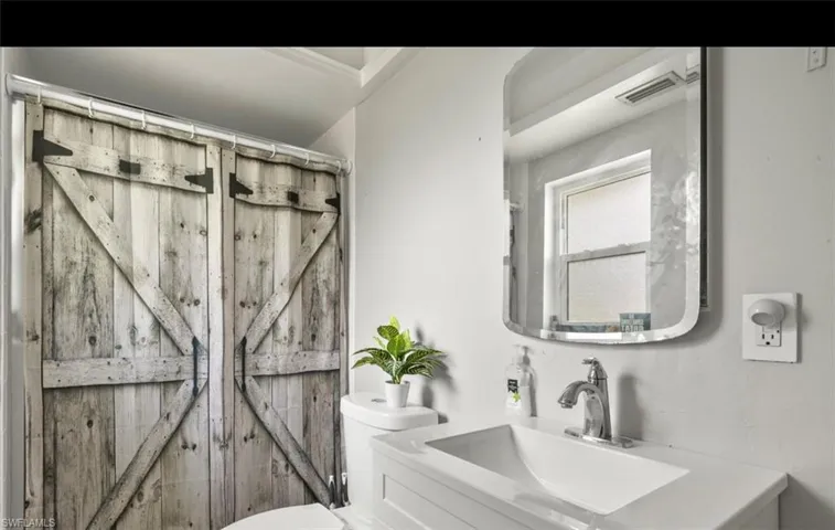 Bathroom with vanity and toilet