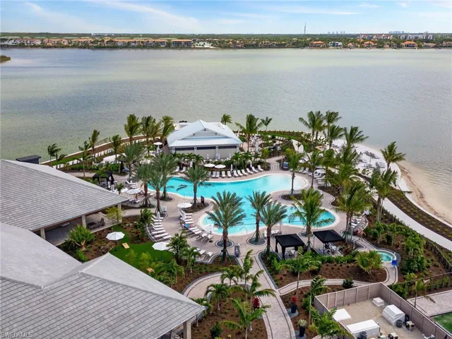 Birds eye view of property with a water view