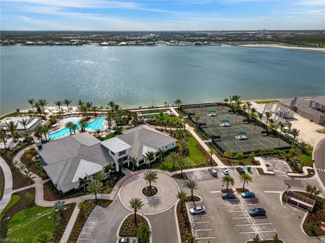 Birds eye view of property with a water view