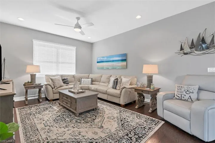 Living room featuring ceiling fan and dark hardwood / wood-style floors