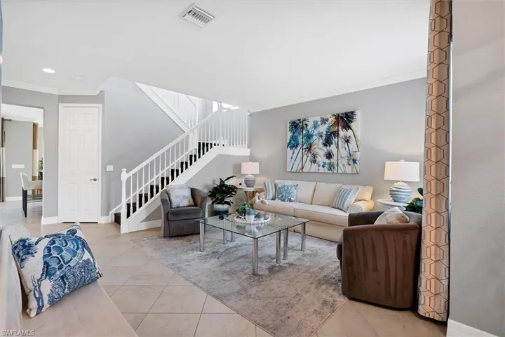 Tiled living room featuring ornamental molding