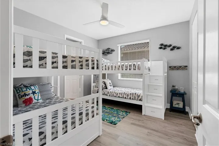 Bedroom featuring ceiling fan and light hardwood / wood-style flooring