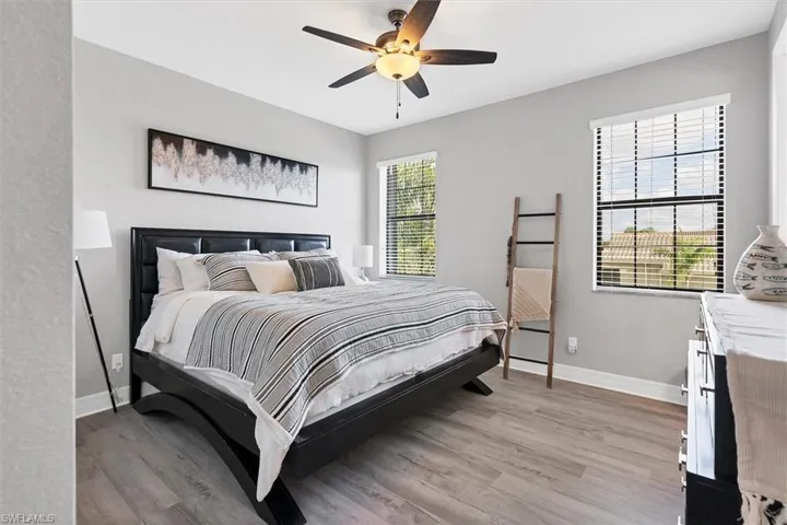 Bedroom with ceiling fan and light wood-type flooring