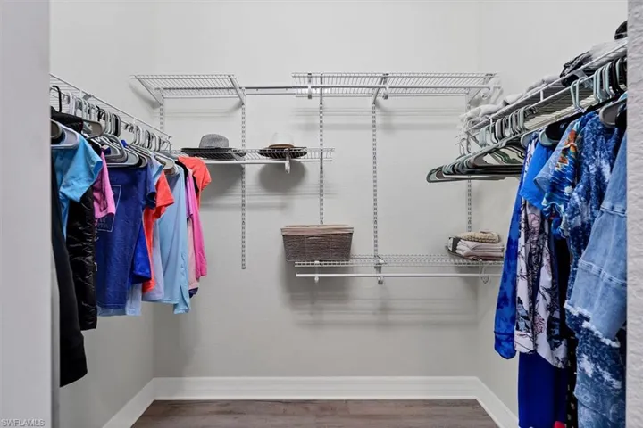 Spacious closet featuring hardwood / wood-style floors