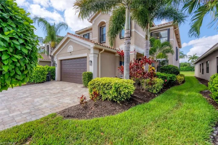 Mediterranean / spanish-style house with a front yard and a garage
