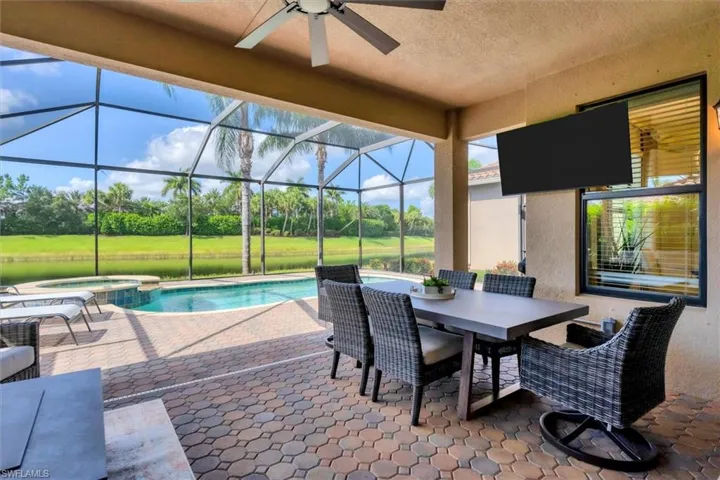 View of pool with a patio, a lanai, an in ground hot tub, and ceiling fan
