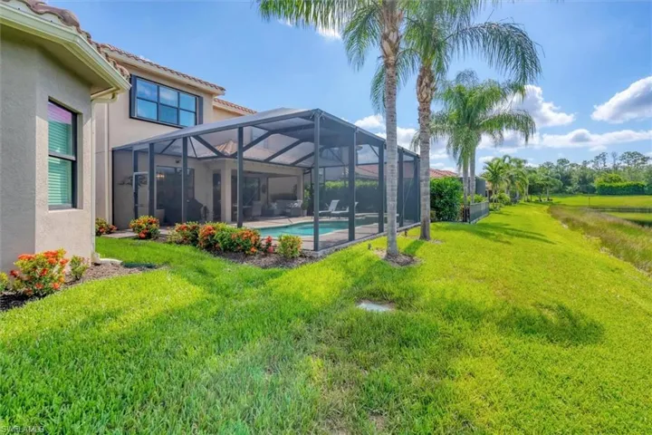 View of yard featuring glass enclosure