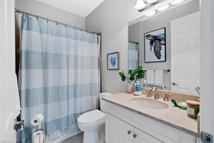 Bathroom with tile floors, oversized vanity, and toilet