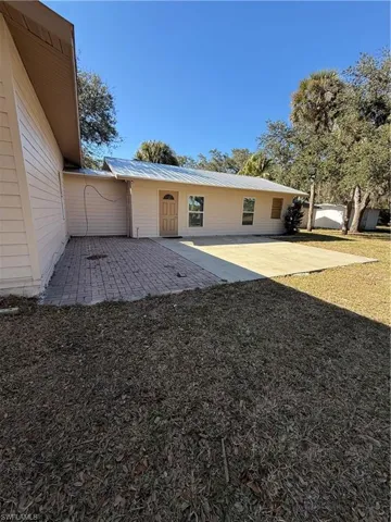 Rear view of property featuring a metal roof