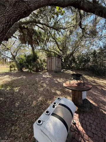 View of yard with a fire pit and a patio