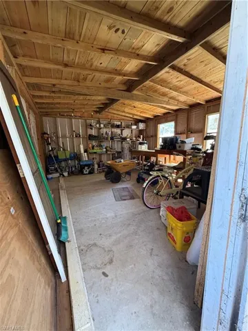 Misc room with a workshop area and concrete flooring