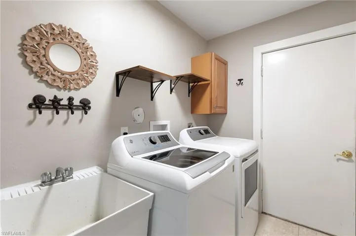 Laundry area with washing machine and clothes dryer and cabinet space
