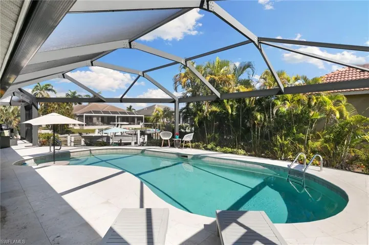 Outdoor pool with a sunroom, a lanai, and a patio