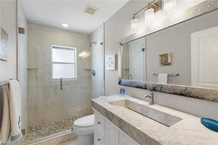 Full bath featuring vanity and a stall shower