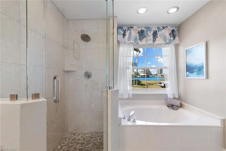 Full bathroom with a shower stall and a garden tub