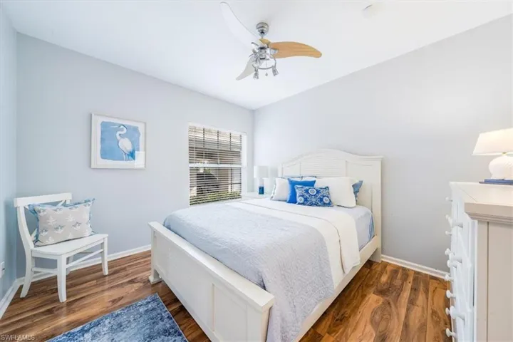 Bedroom with ceiling fan and hardwood / wood-style floors