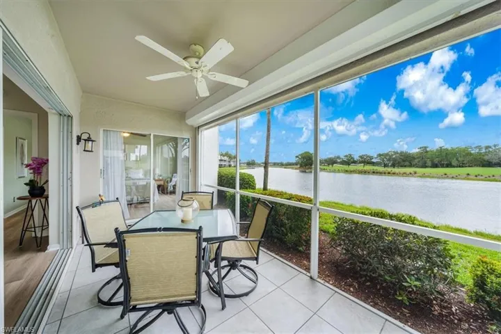 Sunroom featuring ceiling fan and a water view