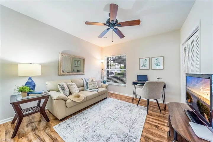 Living room featuring hardwood / wood-style flooring and ceiling fan