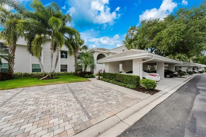 View of front of property featuring a carport and a front lawn