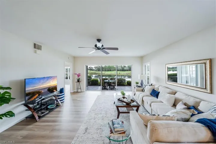 Living room featuring light wood-type flooring and ceiling fan