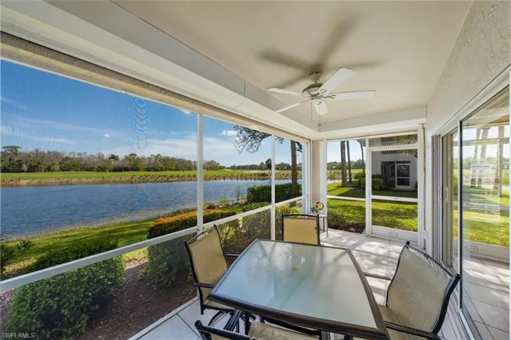 Sunroom / solarium featuring plenty of natural light, ceiling fan, and a water view