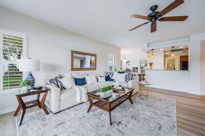 Living room featuring ceiling fan and light wood-type flooring