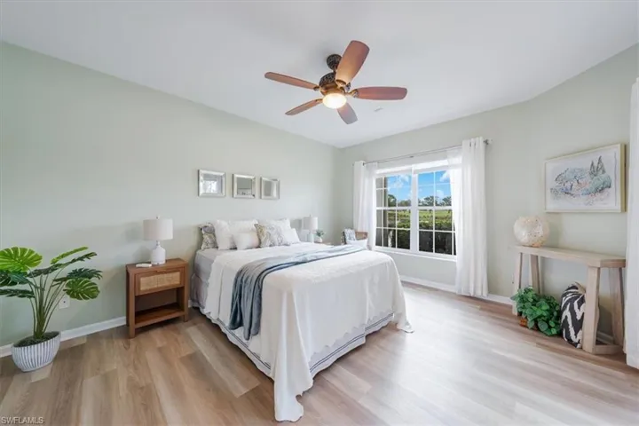 Bedroom with ceiling fan and light hardwood / wood-style flooring