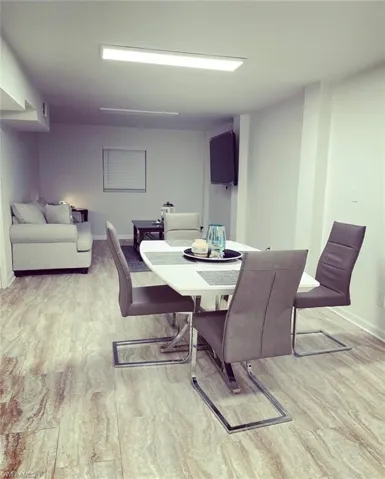 Dining room featuring light wood-style floors and baseboards