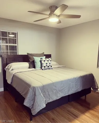 Bedroom with wood finished floors and ceiling fan