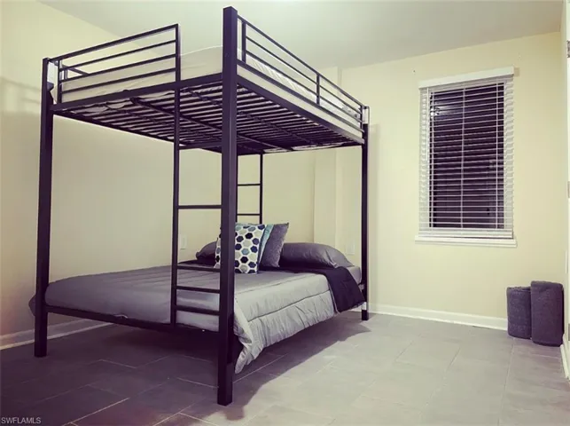 Tiled bedroom with baseboards