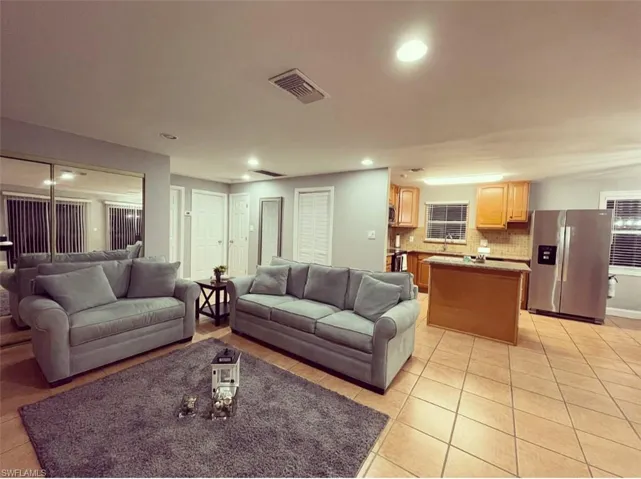 Living area featuring recessed lighting and light tile patterned floors