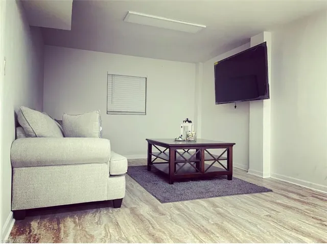 Sitting room with baseboards and light wood finished floors