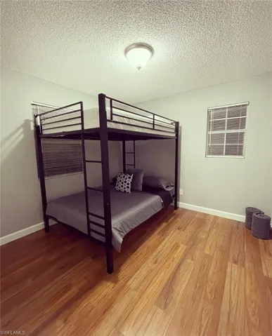Bedroom featuring light wood-style flooring and a textured ceiling