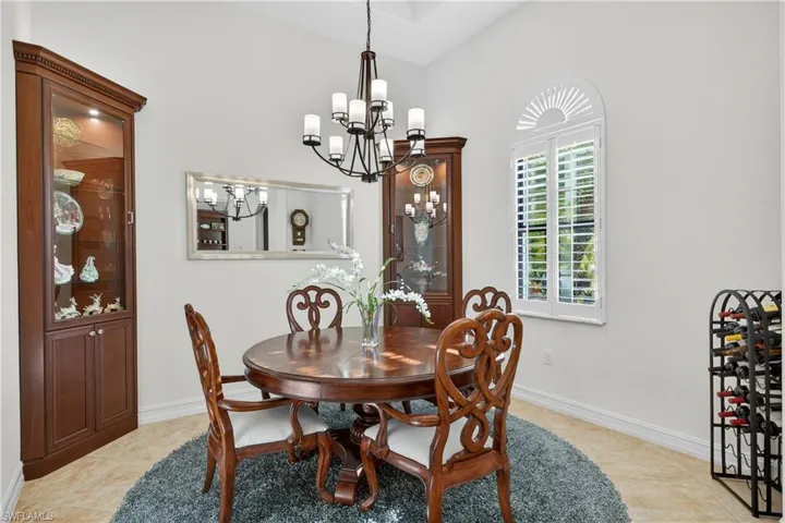 Dining space with New Chandelier, Plantation Shutters, and Diagonal Tile Floors