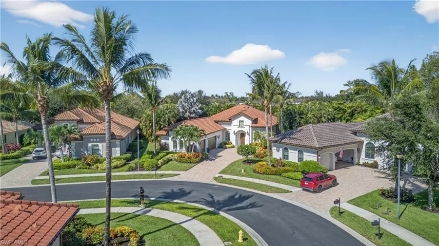 Arieal View Featuring Nearby Properties, Tropical Landscaping, Fabulous Walkable Community with Sidewalks, and Long Entry Paver Lined Driveway