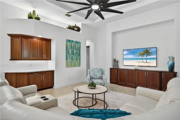 Living Room with Dry Bar, Custom Built-In Cabinetry, and Upgraded Ceiling Fan with Built-In Remote