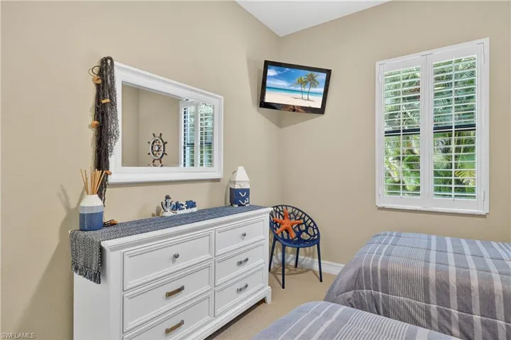 Carpeted 2nd Guest Bedroom Featuring Plantation Shutters, and Mounted TV