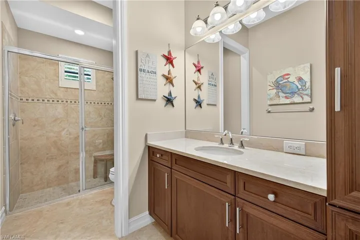 Full Guest Bath Featuring Large Vanity, Separate Shower Room and Toilet, and Built-In Linen Closet