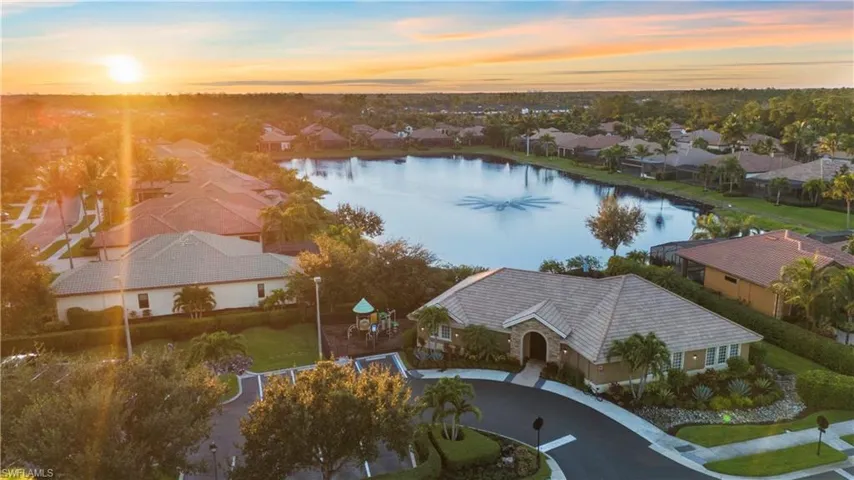 Aerial Perspective of Clubhouse and Large Central Lake with Fountain at Sunset