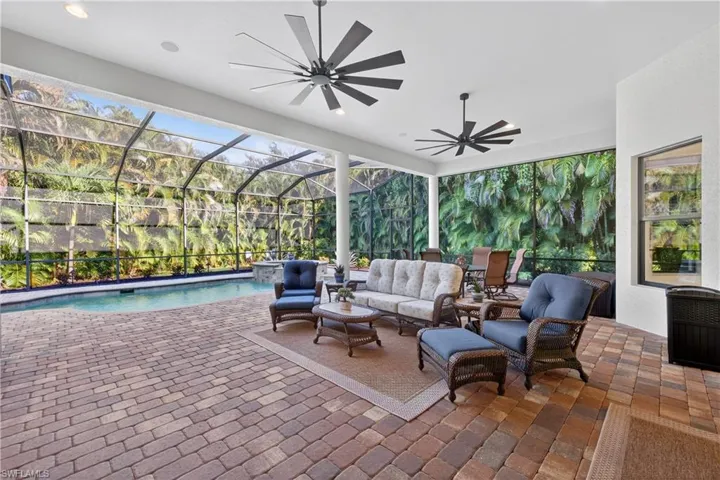View of Lanai Featuring Upgraded Ceiling Fans, Saltwater Pool and Spa, Oversized Outdoor Covered Lanai On Private Lot