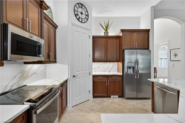 Updated Kitchen with Stainless Steel Appliances, Quartz Backsplash and Counters, and Walk-In Pantry