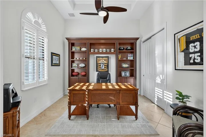 Den or 4th Bedroom Featuring a Built in Book Shelf, Upgraded Ceiling Fan with Built-In Remote, Plantation Shutters, Closet, and Diagonal Tile Floors. French Doors can be Re-Installed if Desired