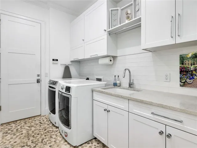 Laundry Room with Custom Cabinets, Subway Tile Backsplash and entry to the 2 car garage