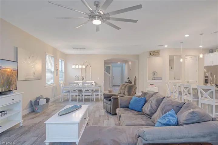 Living room featuring ceiling fan and light hardwood / wood-style floors