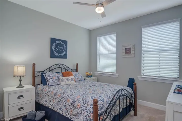 Bedroom featuring light carpet and ceiling fan