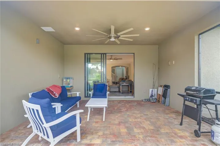 View of patio with ceiling fan and a grill